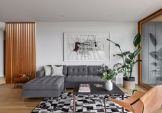 a living room filled with furniture and a painting on the wall