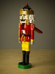 a toy nutcracker is made out of legos and stands on a table