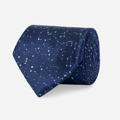 a blue tie with stars on it and white dots in the sky, against a gray background