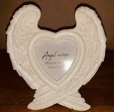 an angel wings photo frame on a table