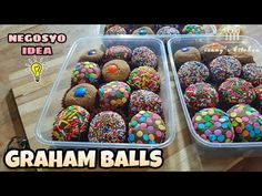 two plastic trays filled with cake balls on top of a wooden table