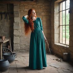 a woman with long red hair in a green dress