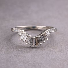 a white gold ring with baguetts of diamonds