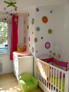 a baby's room is decorated in bright colors