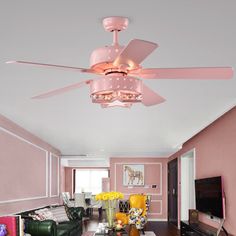 a living room filled with furniture and a ceiling fan in the middle of the room