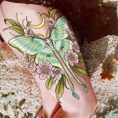 a woman's leg with a butterfly tattoo on it