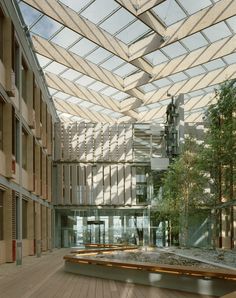 the inside of a building with lots of windows and wood flooring in front of it