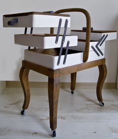 a chair that is sitting on top of a wooden stand with two boxes in it