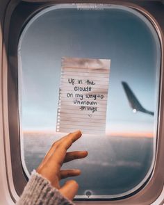 someone holding up a piece of paper with the words up in the clouds on it