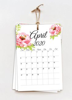 a calendar hanging from a rope with flowers on it and the word november written in black