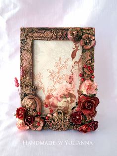 there is a picture frame with flowers on the front and bottom, as well as roses in the middle