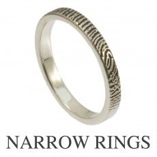 a wedding ring with engraved designs on the side and an inscription below it that reads narrow wedding rings