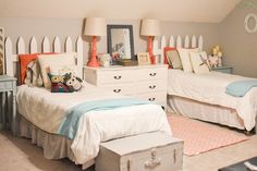 two twin beds in a bedroom with white walls