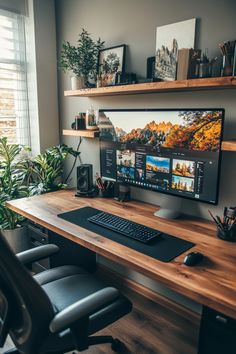 a desktop computer sitting on top of a wooden desk in front of a large window