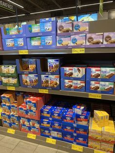 shelves in a grocery store filled with boxes of cereal