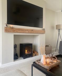 a living room with a fireplace and television above it