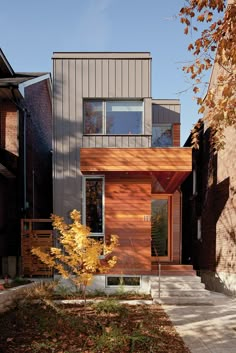 a modern house with wood siding and windows