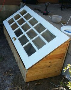 an old window is sitting on top of a wooden box