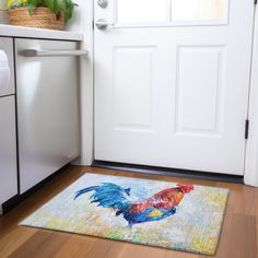 a door mat with a rooster painted on it in front of a white kitchen door