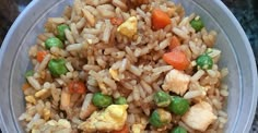 a plastic bowl filled with rice and vegetables