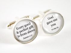 a pair of cufflinks with a compass on them