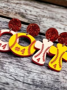 Step up to the plate in style with our personalized baseball/softball acrylic earrings! Crafted in trendy cross or circle designs, these two-tone acrylic earrings are laser-engraved to perfection. Add a touch of glamour with optional red glitter acrylic studs. Express your love for the game with these unique accessories - a home run for any baseball or softball enthusiast! Swing into fashion, order your personalized earrings today! Sports Earrings, Personalized Earrings, Circle Designs, Homemade Earrings, Into Fashion, Glitter Acrylic, Unique Accessories, Glitter Acrylics, Home Run