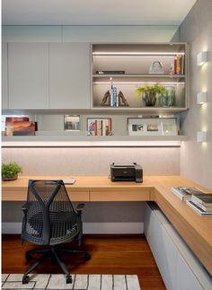 an office with a desk, chair and bookshelf