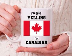 a woman holding a coffee mug with the canadian flag on it and i'm not yelling i'm canadian