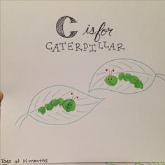 a hand holding up a piece of paper with the words c is for caterpillar on it