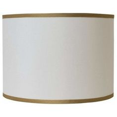 a white lampshade with a gold trim around the bottom and an off - white drum light shade