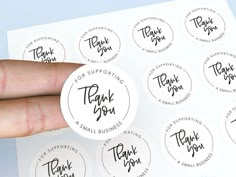 a hand holding a sticker that says thank you for supporting the small businesses in their business