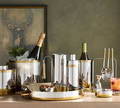 a table topped with lots of different types of wine bottles and glasses on top of it