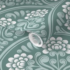 a green and white wallpaper with flowers on it