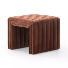 a stool made out of brown velvet with pleated sides and an attached foot rest