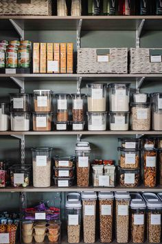 the shelves are filled with many different types of food in containers and bins on them