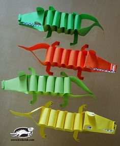 four different types of origami alligators on a table