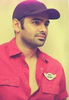 a man wearing a red shirt and hat