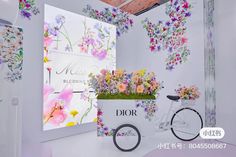 a flower shop with flowers on the wall and a bicycle parked in front of it