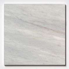 a white marble tile that looks like it is being used as a wall art piece