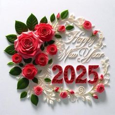 red roses and green leaves are arranged in the shape of a happy new year sign