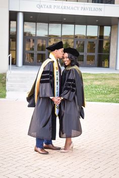 a man and woman in graduation gowns standing together