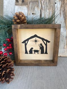 a christmas nativity scene is displayed in a wooden frame