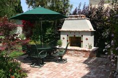 an outdoor patio with table, chairs and umbrella