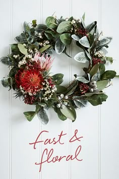 a floral wreath hanging on the side of a white door that says, fast and floral