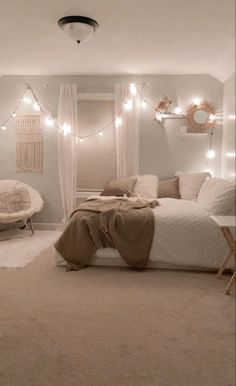 a bedroom with lights strung from the ceiling