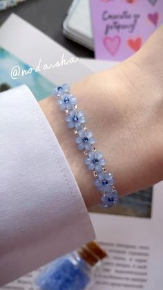 a person wearing a bracelet with blue beads