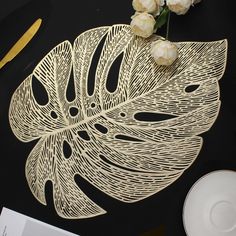 a table topped with white flowers next to a plate and knife on top of it