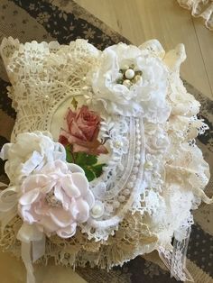 an old lace doily with pink and white flowers