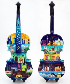 two colorful violin sculptures are shown against a white background with the city skyline painted on it