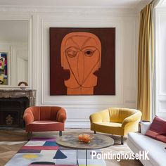 a living room filled with furniture and a painting on the wall